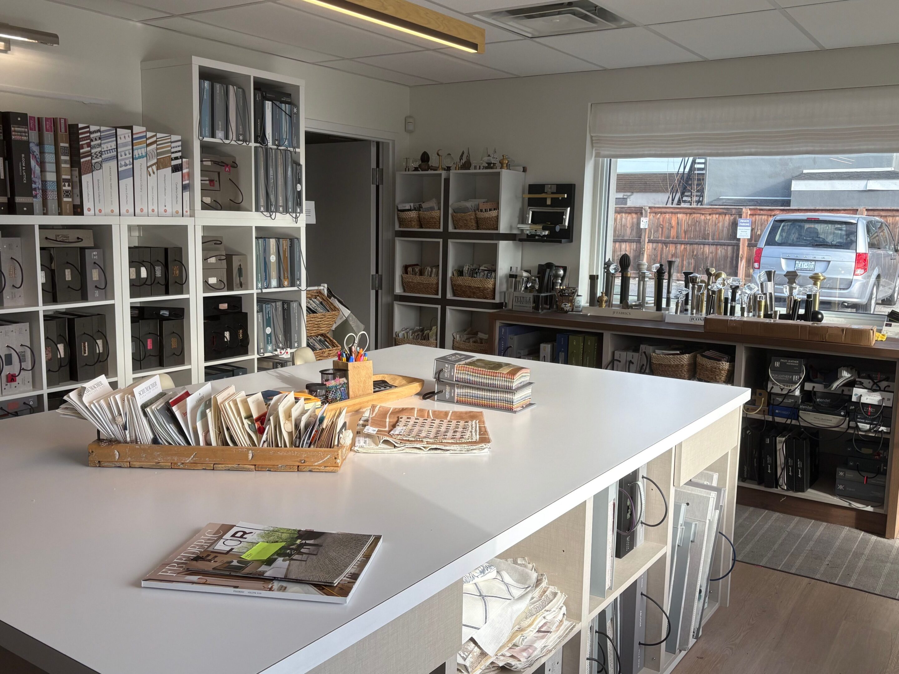 Bright, modern kitchen with white countertops and stainless steel appliances.